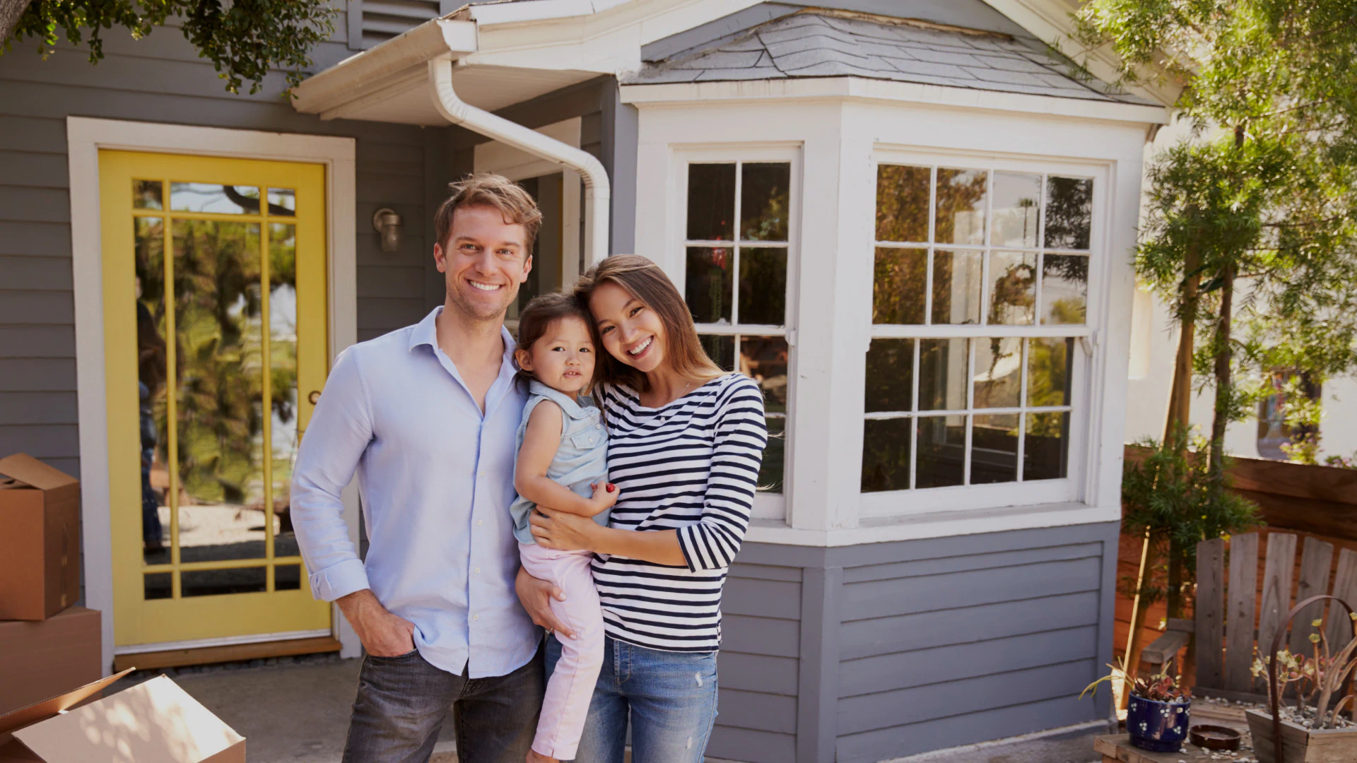 family standing in front of house
